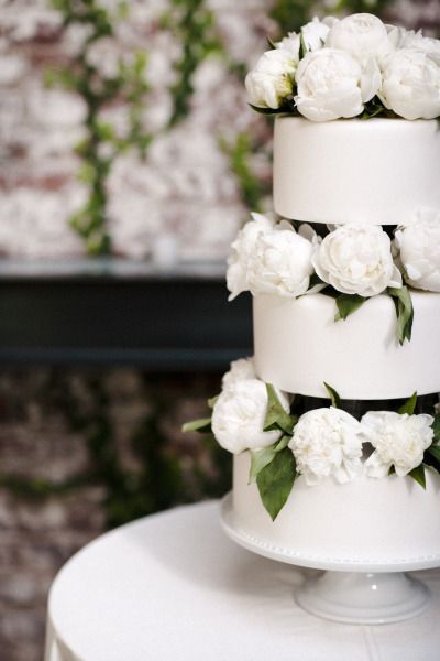 Gorgeous wedding cake for a white wedding with peonies. 
