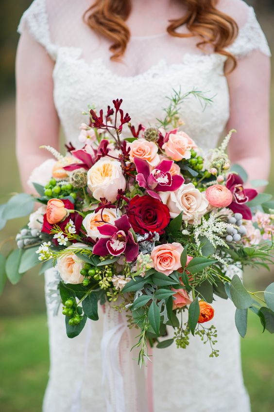 Glorious, lush, full bridal bouquet. David Austin's Juliet garden rose takes center stage along with cymbidium orchids, Black beauty roses, Quicksand roses, stock, ranunculus, brunia berries, astilbe, rosemary, kangaroo paw, and assorted foliage. 