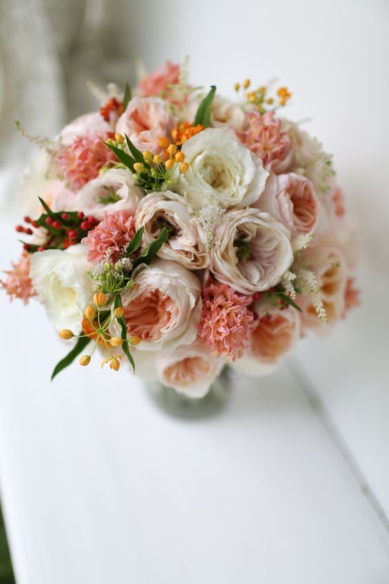 Stunning peachy-pink wedding bouquet with Juliet, Charity and Patience from the David Austin roses collection.